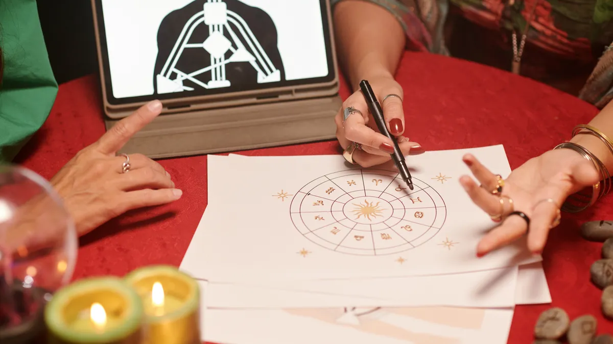 natal chart: hands drawing astrology chart illustration