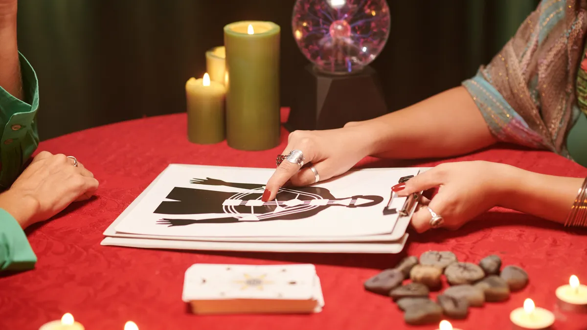 natal chart reading free: hands pointing at astrology chart illustration for this article